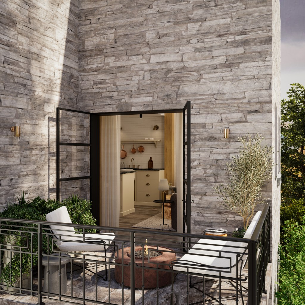 Exterior view of Lake District cabin by Galatea Studio, showing the stone façade, black-framed French doors, and intimate terrace with firepit and outdoor seating.
