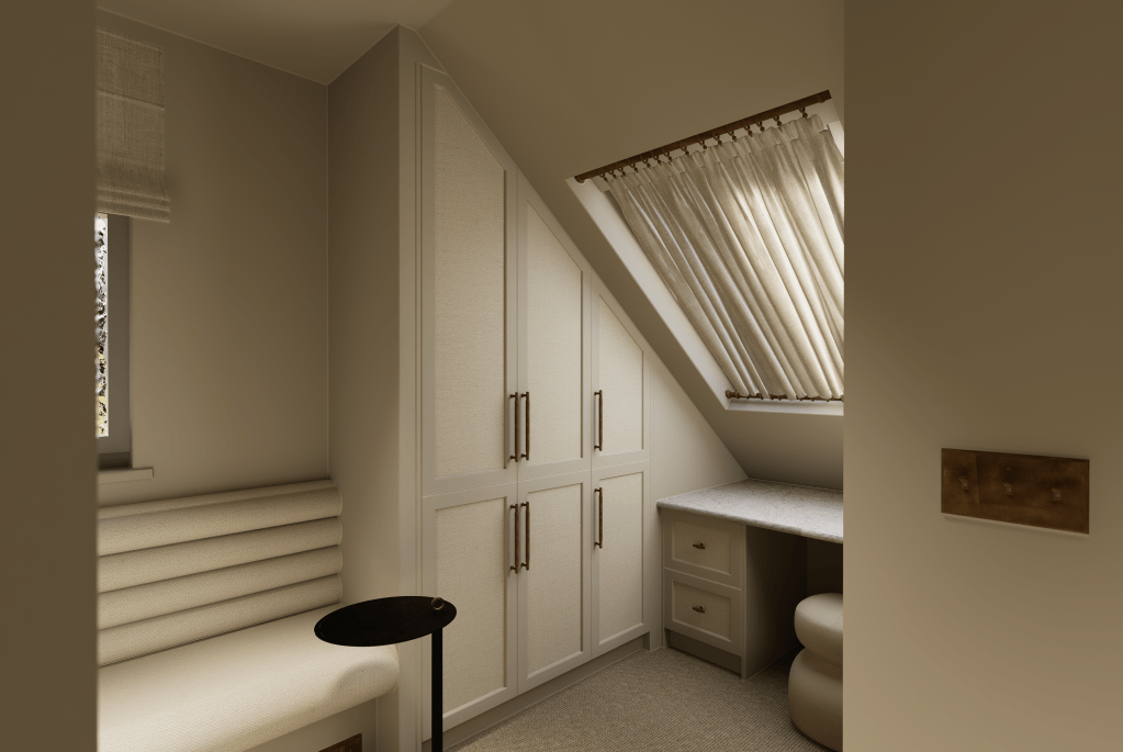 A close-up of a minimalist walk-in wardrobe in Saddleworth featuring handleless cream cabinetry, a marble-top island, and curated neutral accessories.