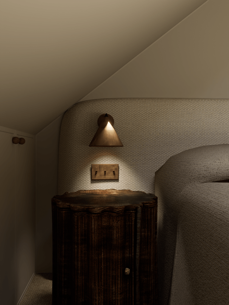 A close-up of a modern bronze wall sconce above a dark fluted wood bedside table in a minimalist Saddleworth bedroom.