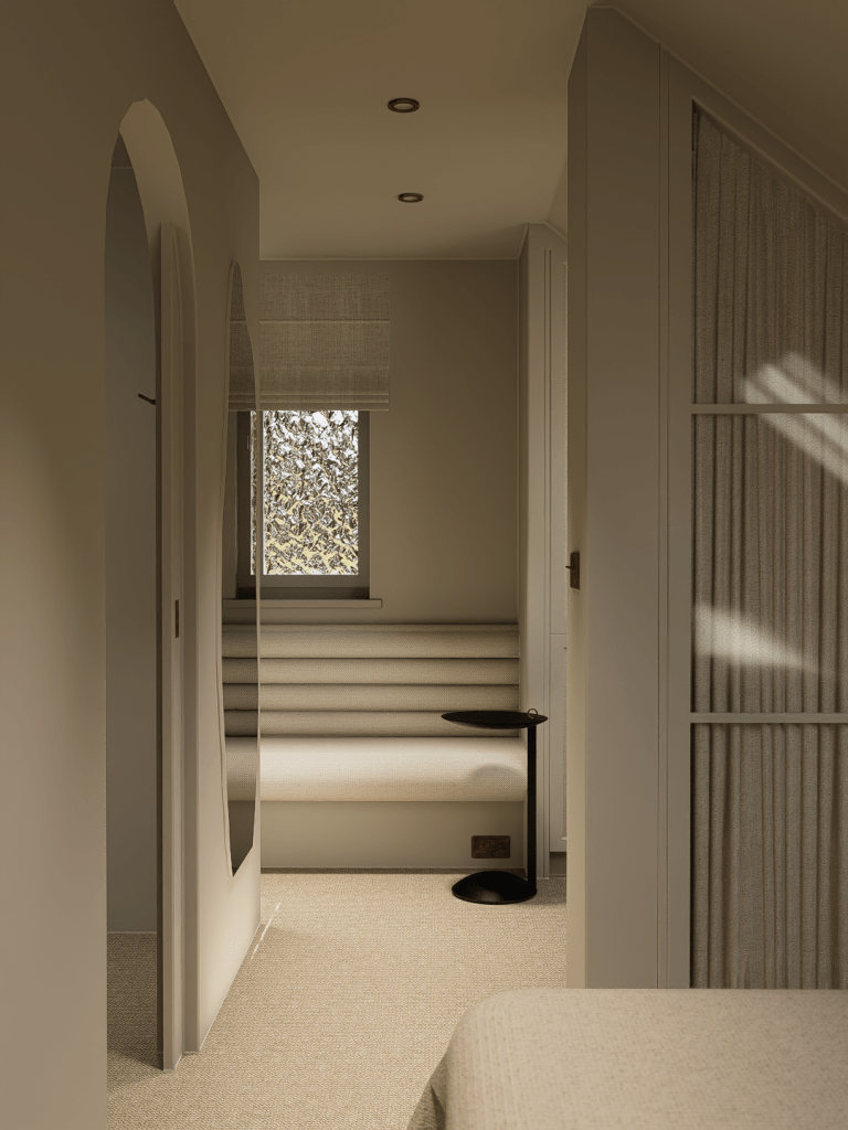 A minimalist cottage landing in Denshaw featuring a soft arched doorway, bespoke built-in wardrobes, and tactile neutral textures.